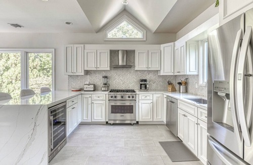 Northwest Harbor House | Modern, coastal-style home with flooding natural light, a private pool, a.