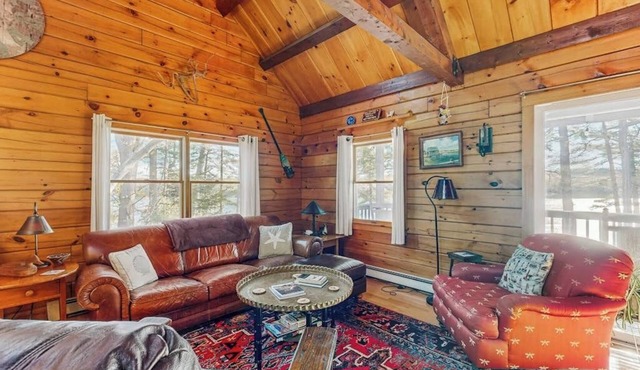 Charming riverfront home with cozy interiors, dock, and scenic deck views